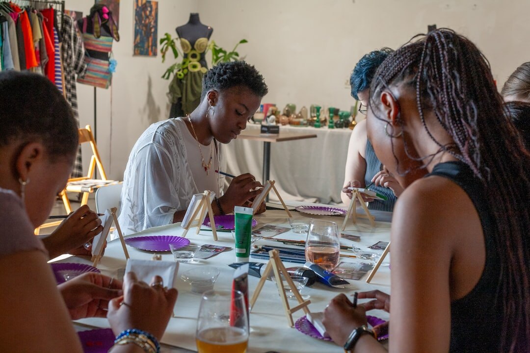 Group of seniors painting together in an art workshop