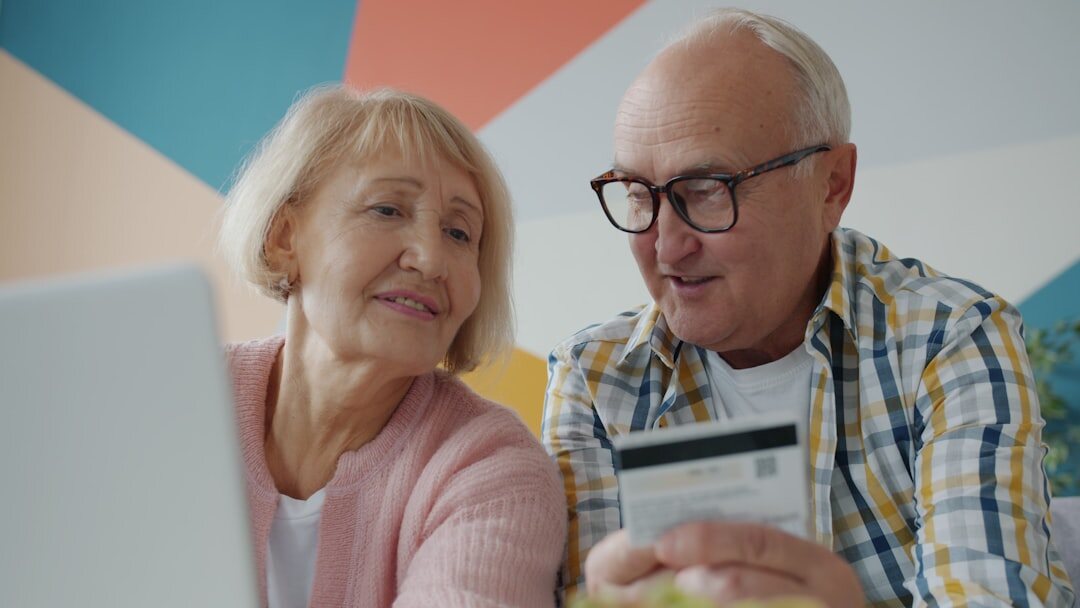 Senior couple shopping together and checking a receipt with a discount
