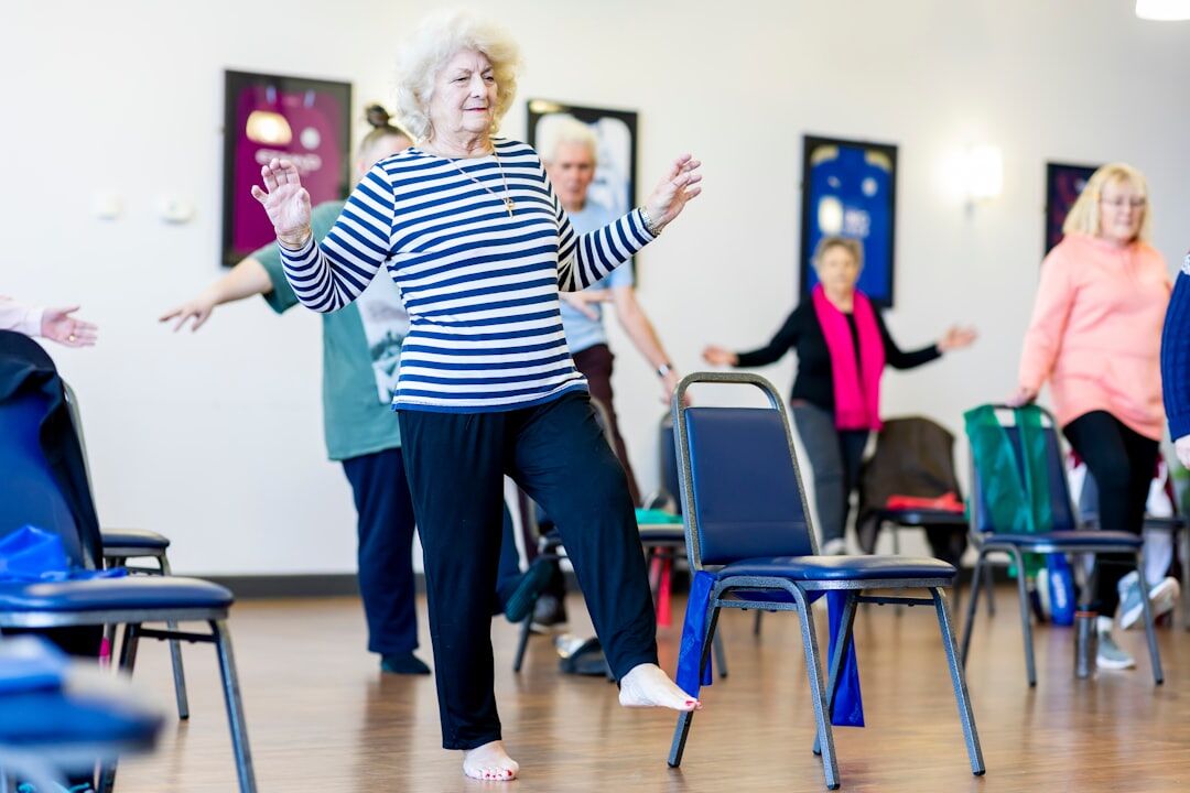 Seniors doing a gentle stretching exercise class together