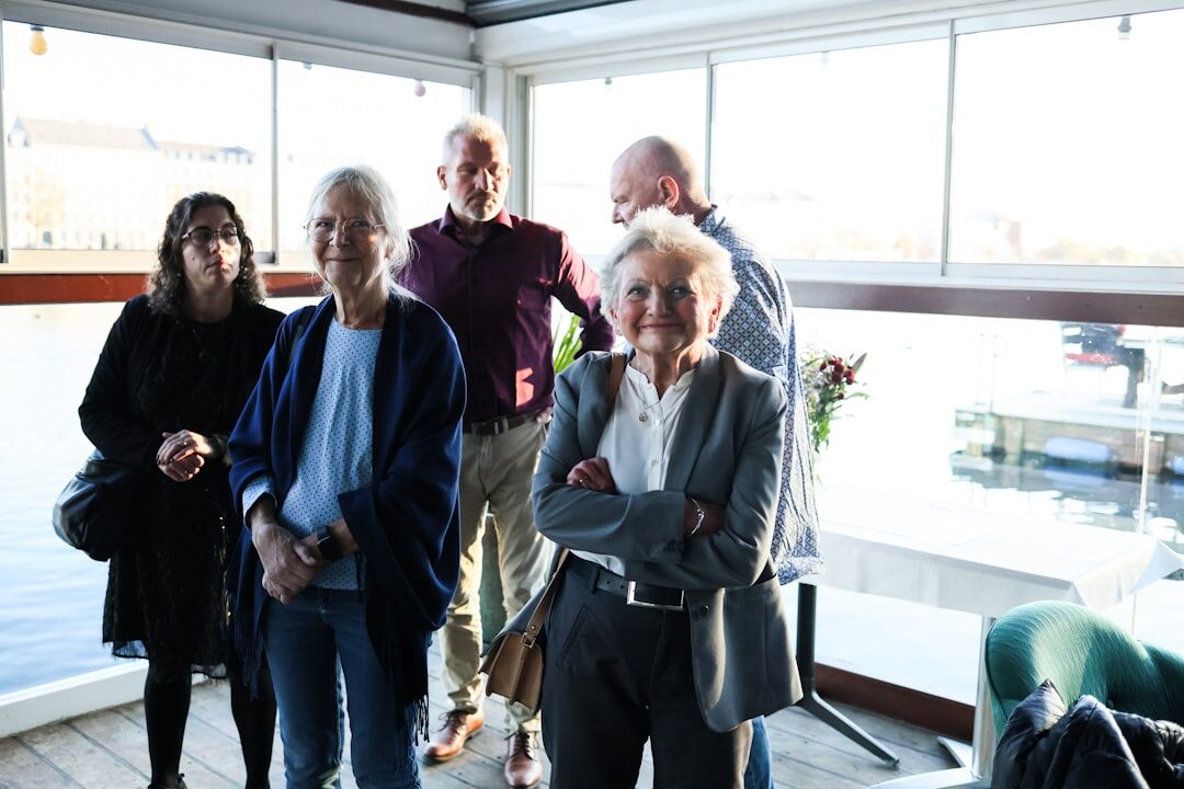 Staff team of a senior community club standing together indoors
