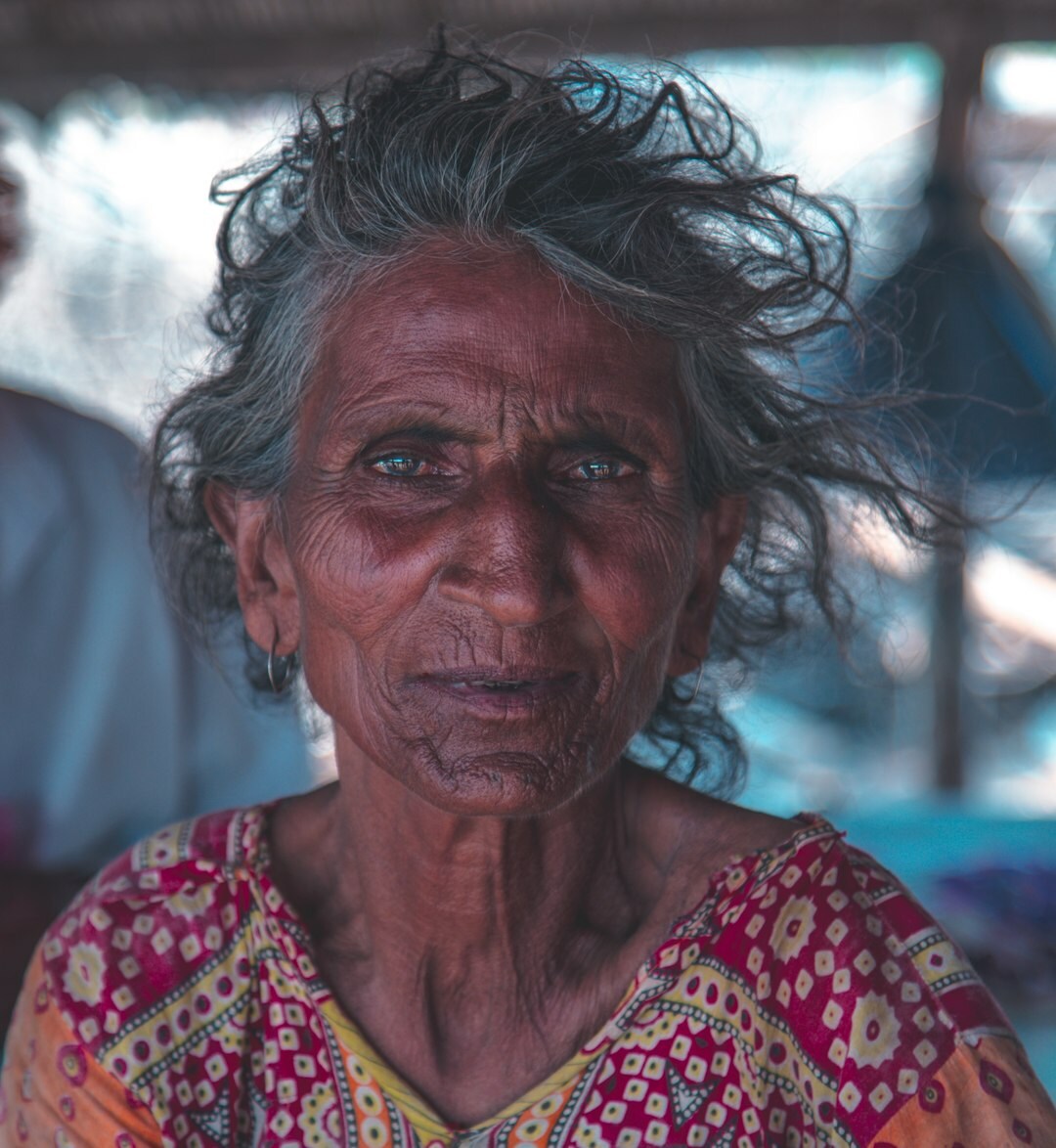 Portrait of a warm smiling senior woman with curly hair